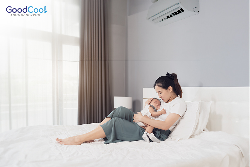 Mother cuddling newborn in an air-conditioned room