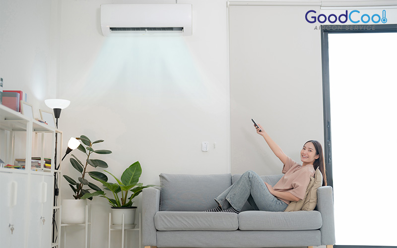 woman turning on her air conditioner